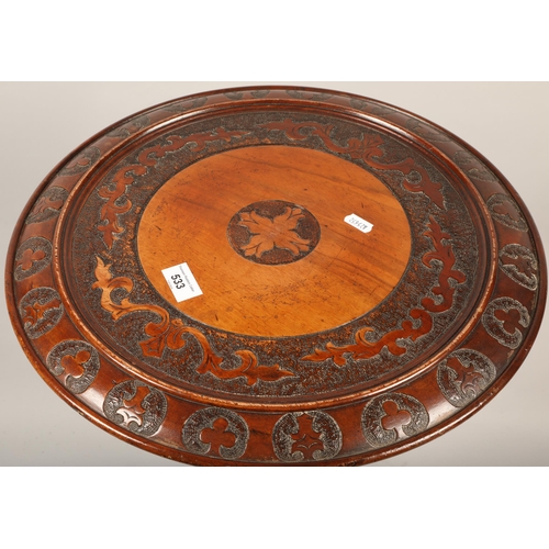 533 - Hardwood drum table with ornate designs in relief