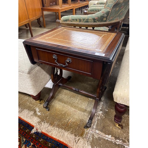 580 - Small drop leaf leather topped sofa table, claw feet on castors, 53 cm high