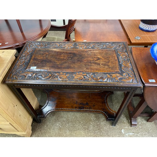 602 - Oak Hall table, top with sea creatures carved in relief, with shelf, 49 x 89 x 77 cm