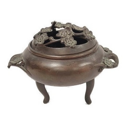 Antique Chinese bronze koro with foliate pierced cover and handles, on tripod feet, with stand, 13cm high.