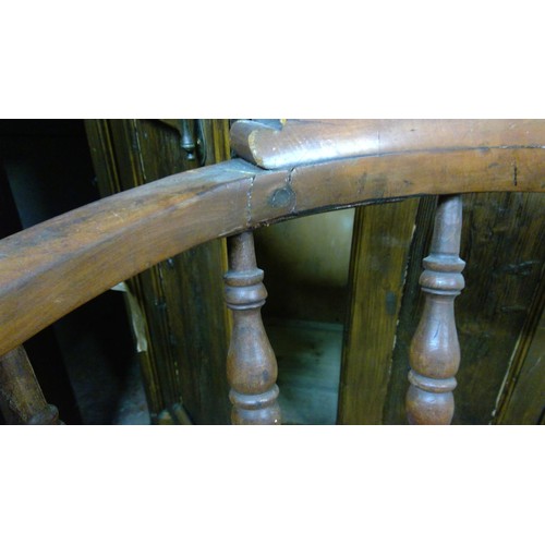 261 - Antique smokers bowl style chair with spindle back, saddle seat, raised on turned baluster supports.