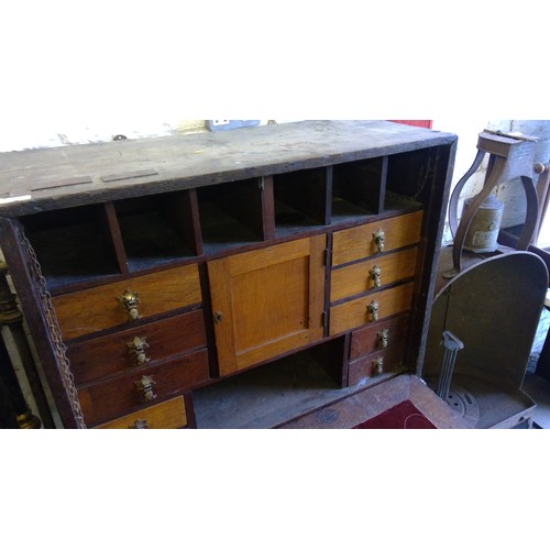 238 - Antique oak campaign cabinet on stand, the fall front with fully fitted interior including drawers, ... 