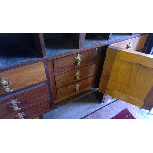 238 - Antique oak campaign cabinet on stand, the fall front with fully fitted interior including drawers, ... 