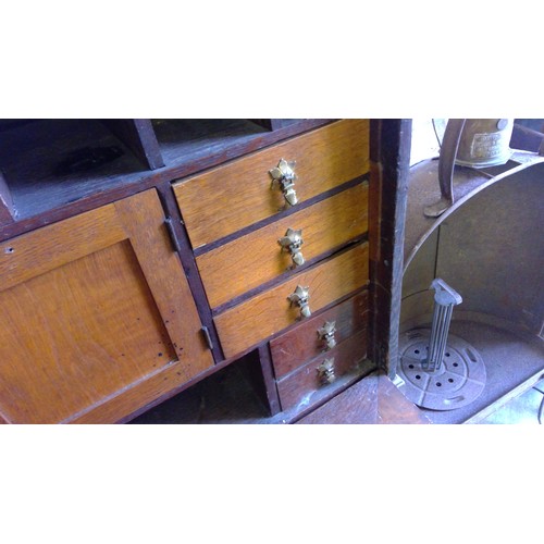 238 - Antique oak campaign cabinet on stand, the fall front with fully fitted interior including drawers, ... 