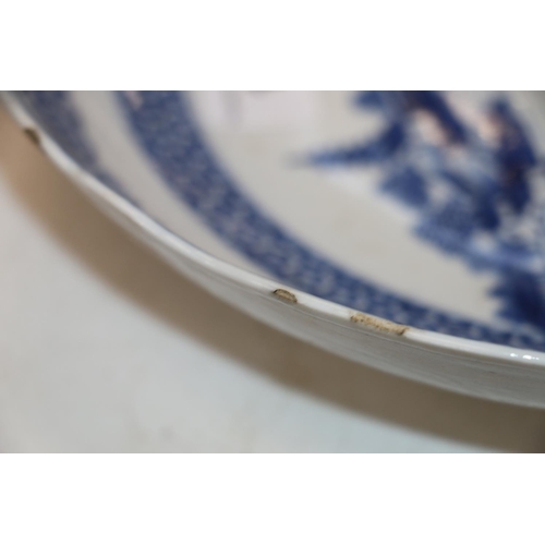 137 - Four Chinese blue and white dishes decorated with pavilion and garden scenes, 25cm and 23cm diameter... 