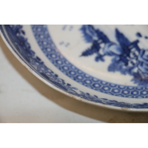 137 - Four Chinese blue and white dishes decorated with pavilion and garden scenes, 25cm and 23cm diameter... 