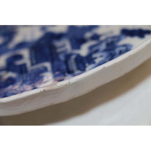 139 - Chinese blue and white porcelain dish of boteh form decorated with pavilion garden scene, 19cm high.