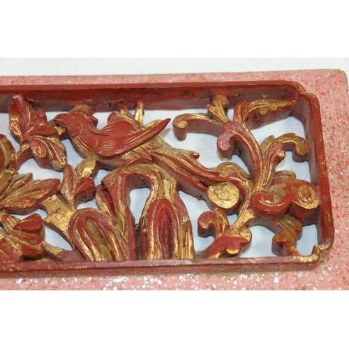 19 - Chinese lacquered pierced panel depicting birds among prunus, 38cm x 15cm.