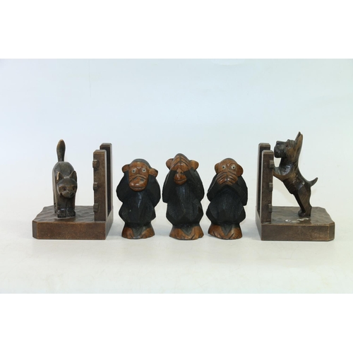 28 - Pair of bookends in the form of a dog peering over the fence at a cat, and three carved models of Th... 