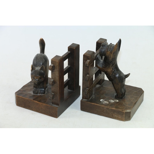 28 - Pair of bookends in the form of a dog peering over the fence at a cat, and three carved models of Th... 