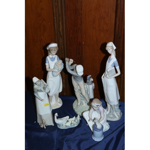 33 - Lladro figurines to include a nurse, a golfer, a nurse with a kitten, a lady with a basket, a Lladro... 