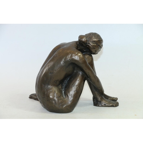 45 - Bronzed composite model of a seated female, 19cm high.