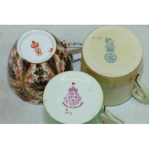 5 - Three coffee cans and saucers to include Royal Doulton Pipes of Pan,  Royal Crown Derby Imari and Ro... 