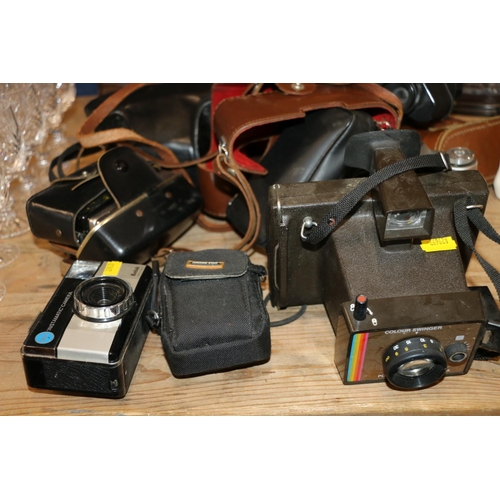 123 - Vintage cameras and binoculars to include a Zenit 3M, etc.