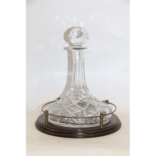 124 - Edinburgh Crystal ship's decanter on a mahogany stand.