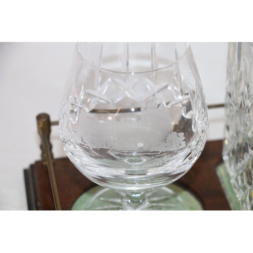 125 - Glass decanter and a pair of brandy glasses with Edinburgh and Balmoral castle etchings, on mahogany... 