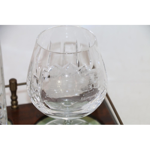 125 - Glass decanter and a pair of brandy glasses with Edinburgh and Balmoral castle etchings, on mahogany... 