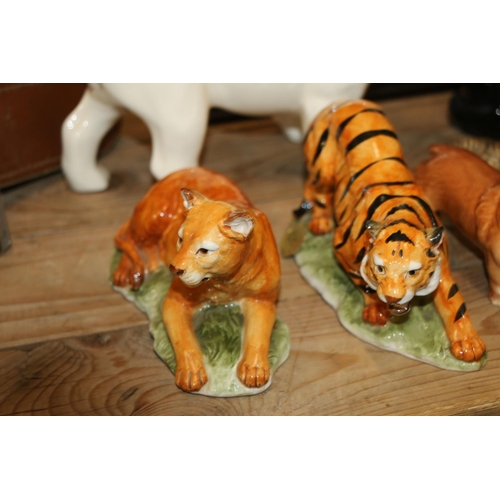 126 - Ceramic models  to include a white bulldog, 17cm, a black cat, wild animals, and others.