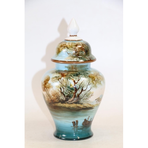 128 - Continental porcelain vase and cover painted with lakeside scene, 26cm high.