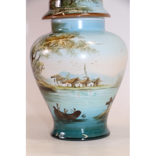 128 - Continental porcelain vase and cover painted with lakeside scene, 26cm high.