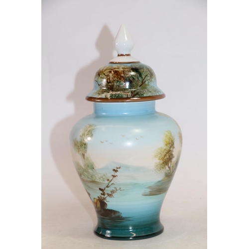 128 - Continental porcelain vase and cover painted with lakeside scene, 26cm high.