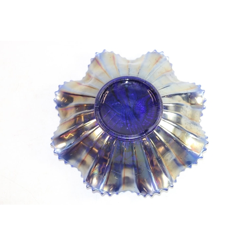 137 - Early 20th century blue iridescent carnival glass frilled bowl with peacock on fence design, 20cm wi... 