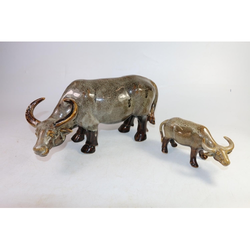 139 - Two drip mottled glaze ceramic models of water buffalo, largest 36cm long.  (2)