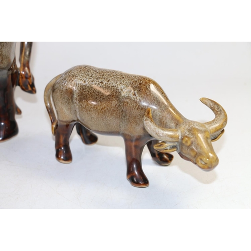 139 - Two drip mottled glaze ceramic models of water buffalo, largest 36cm long.  (2)