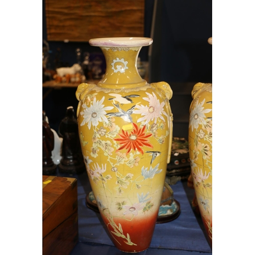 151 - Pair of large continental pottery vases decorated in a chinoiserie style, 56cm high.