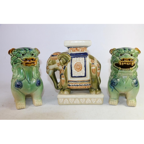 155 - Pair of temple dog models in a Sancai glaze, and a small Chinese elephant stand, largest 19cm high.