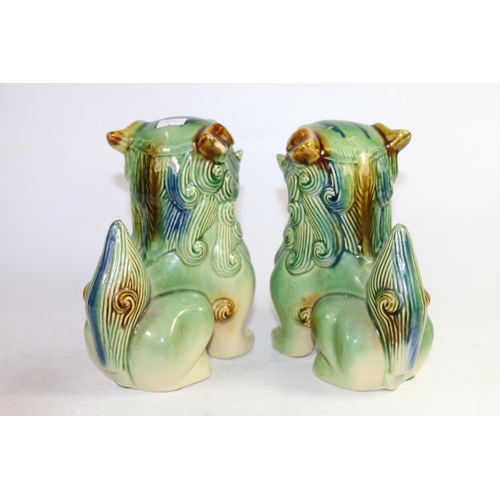 155 - Pair of temple dog models in a Sancai glaze, and a small Chinese elephant stand, largest 19cm high.