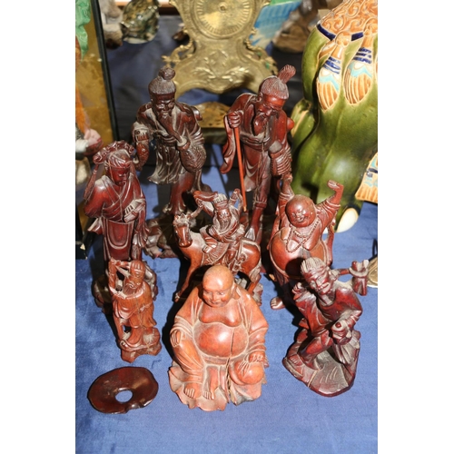 157 - Eight carved wooden oriental figurines of scholars and Buddhas, etc., largest 26cm high.