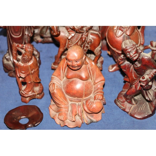 157 - Eight carved wooden oriental figurines of scholars and Buddhas, etc., largest 26cm high.