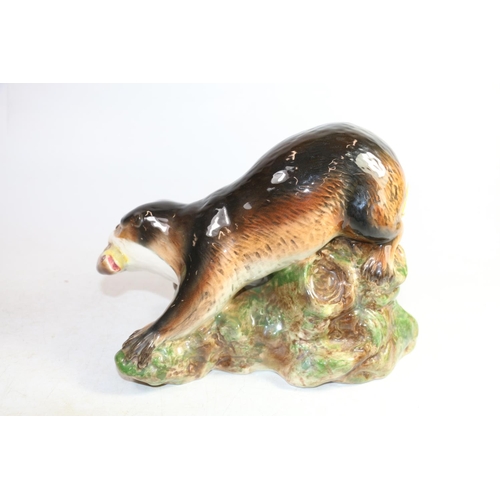 161 - Sylvac pottery sea otter holding a trout, 24cm long.