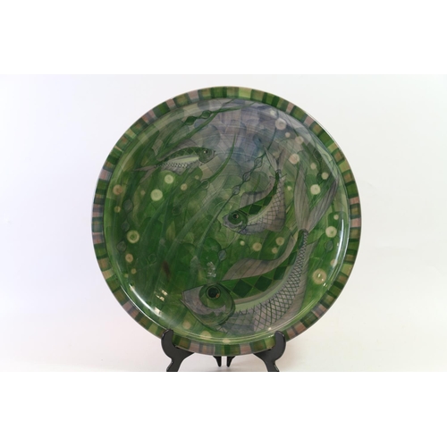 63 - Jersey Pottery charger decorated with fish, 36cm diameter.