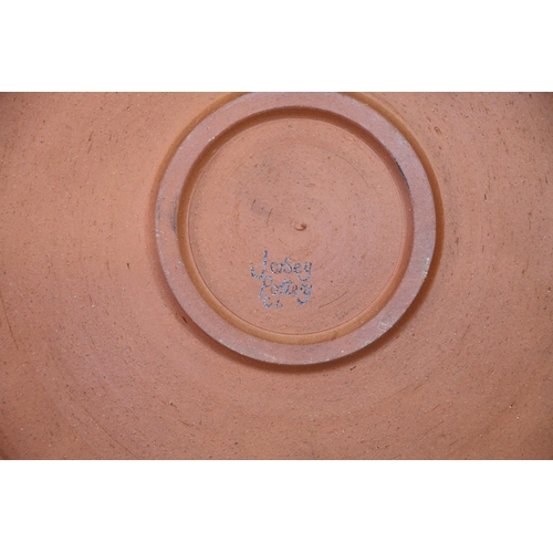 63 - Jersey Pottery charger decorated with fish, 36cm diameter.