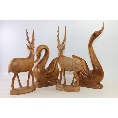 75 - Two carved treen birds and two carved treen antelopes, largest 43cm high.  (4)