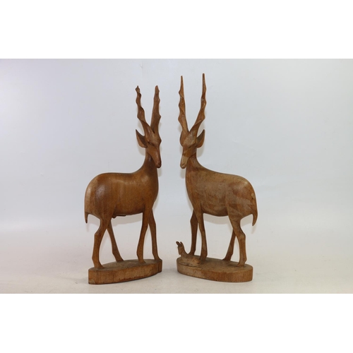 75 - Two carved treen birds and two carved treen antelopes, largest 43cm high.  (4)