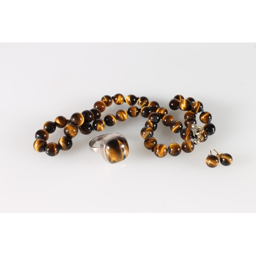 523 - South African Sterling silver tigers eye ring, a similar neck chain and pair of matching earrings.