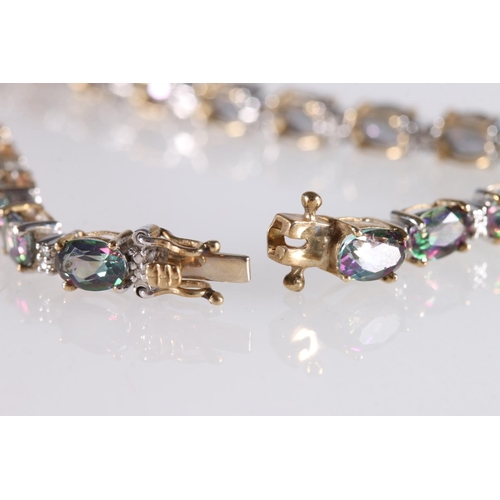 547 - 9ct gold tennis bracelet set with small diamonds and multicoloured semi-precious stones, 9.6g gross,... 