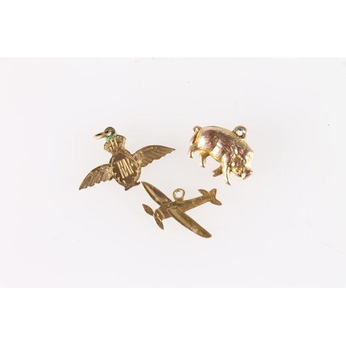 593 - Three 9ct gold charms to include pig, spitfire and RAF wings, 2.1g.