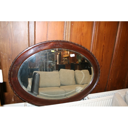 730 - Mahogany framed oval wall mirror, 91cm wide.