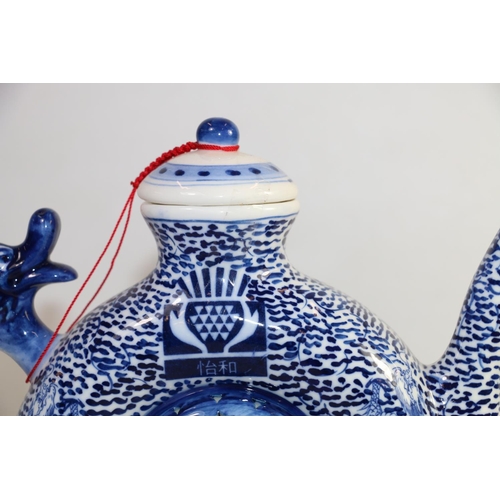 169 - 20th century Chinese style moon shape underglaze blue and white teapot with dragon handle decorated ... 