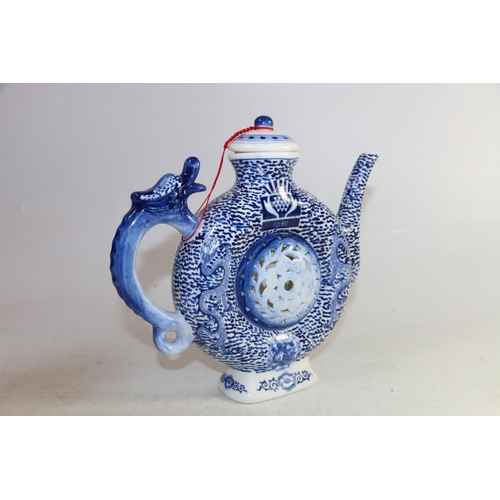 169 - 20th century Chinese style moon shape underglaze blue and white teapot with dragon handle decorated ... 