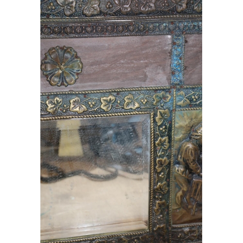 215 - Brass and glass hall mirror with integral hooks, decorated in relief with tavern scenes.