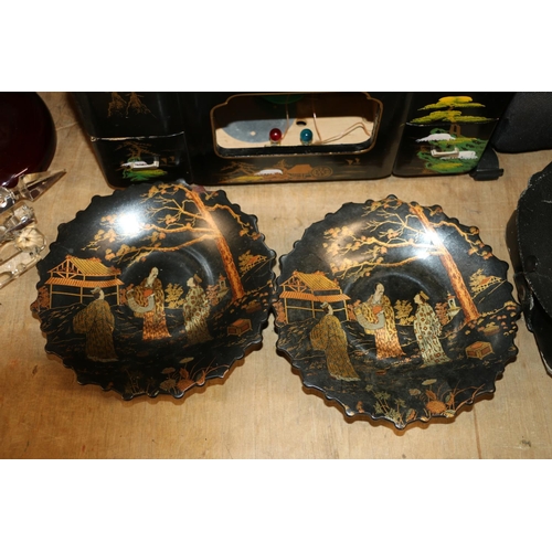 220 - Two Meiji period Japanese black lacquer dishes decorated in gilt with garden scenes, and two later J... 