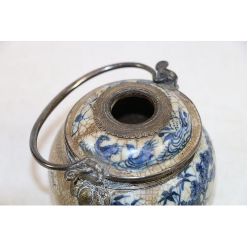 246 - Oriental blue and white pottery pot with metal handle and metal mounts in the form of hanging bats, ... 