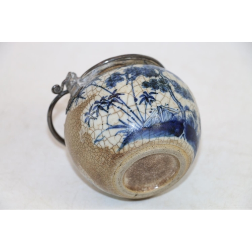 246 - Oriental blue and white pottery pot with metal handle and metal mounts in the form of hanging bats, ... 