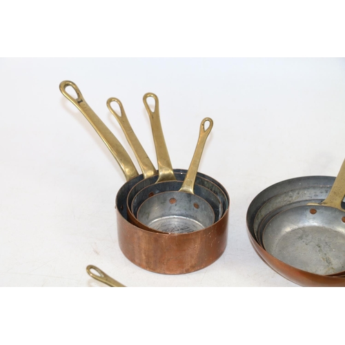 247 - Graduated sets of small brass and copper kitchen pan measures.