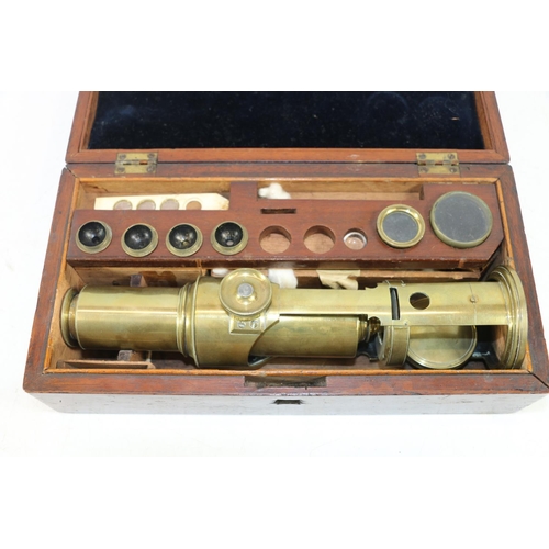 250 - Late 19th century brass microscope with lenses and accessories, in original mahogany case.